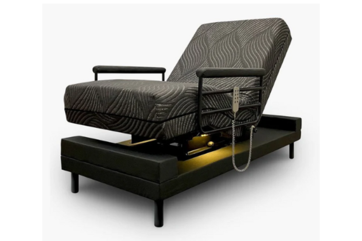A green adjustable medical bed in a reclined position.
