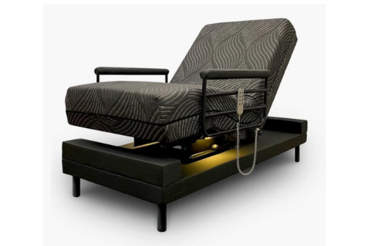 A green adjustable medical bed in a reclined position. 